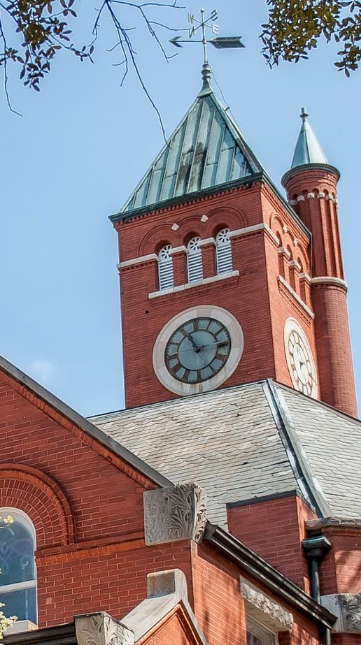 The clock tower of Cornerstone Presbyterian Church against a blue sky